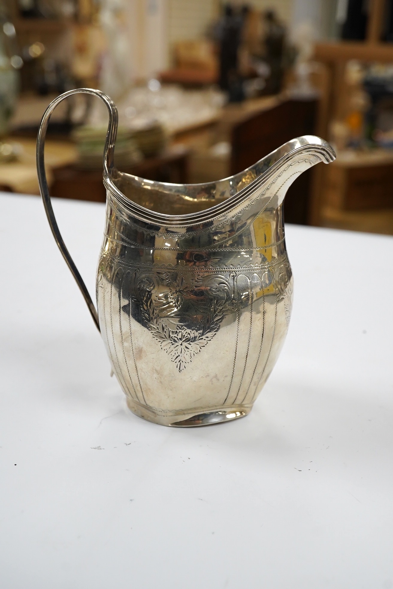 A George III engraved silver helmet shaped cream jug, London, 1801, 12.4cm, 3.4oz. Condition - poor